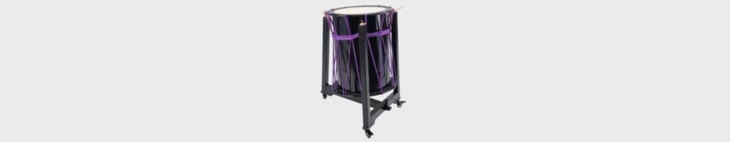 A black Japanese Okedo-daiko (rope-tuned Taiko drum) with vibrant purple ropes, mounted on a black metal rolling stand with wheels, isolated on a light gray background.