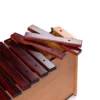 JINLEI box xylophone low pitch BXL-16 close-up showing removable rosewood accidental bars with gold letter markings and rubber mounting pins on natural wood box