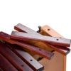 JINLEI box xylophone mid pitch BXM-22 close-up showing removable rosewood accidental bars with gold letter markings and rubber mounting pins on natural wood box