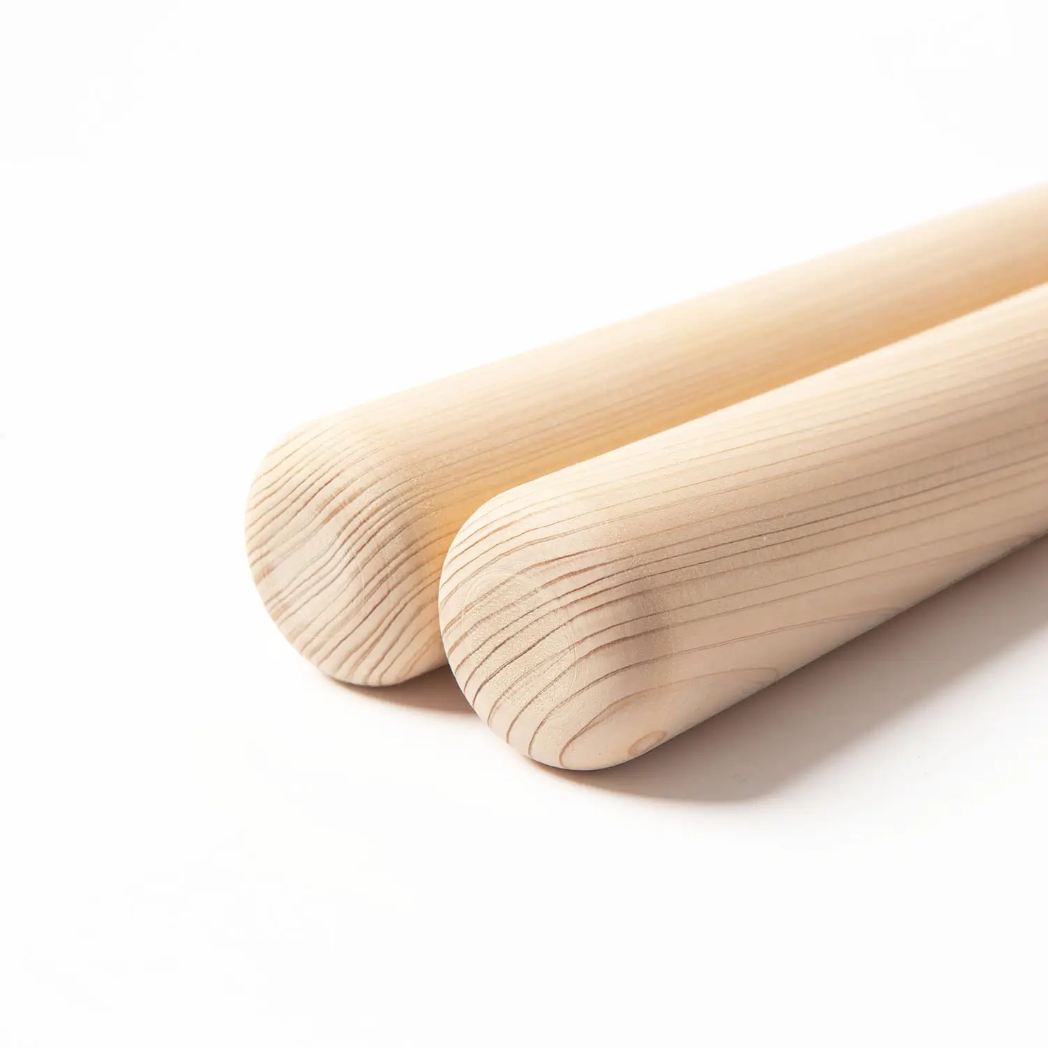 JINLEI hinoki tapered bachi for nagado taiko - close-up of rounded striking tips showing beautiful hinoki wood grain detail