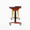 JINLEI marimba MLP-52 side view from high end showing short gold resonator pipes, height-adjustable black center post, and cherry wood caster base