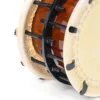 Close-up of JINLEI 3Cyoukake Shime Daiko bolt drum showing stitched leather drumhead rim, dual black metal hoops with threaded bolt and nut tension hardware with leather washers against amber lacquered wood shell