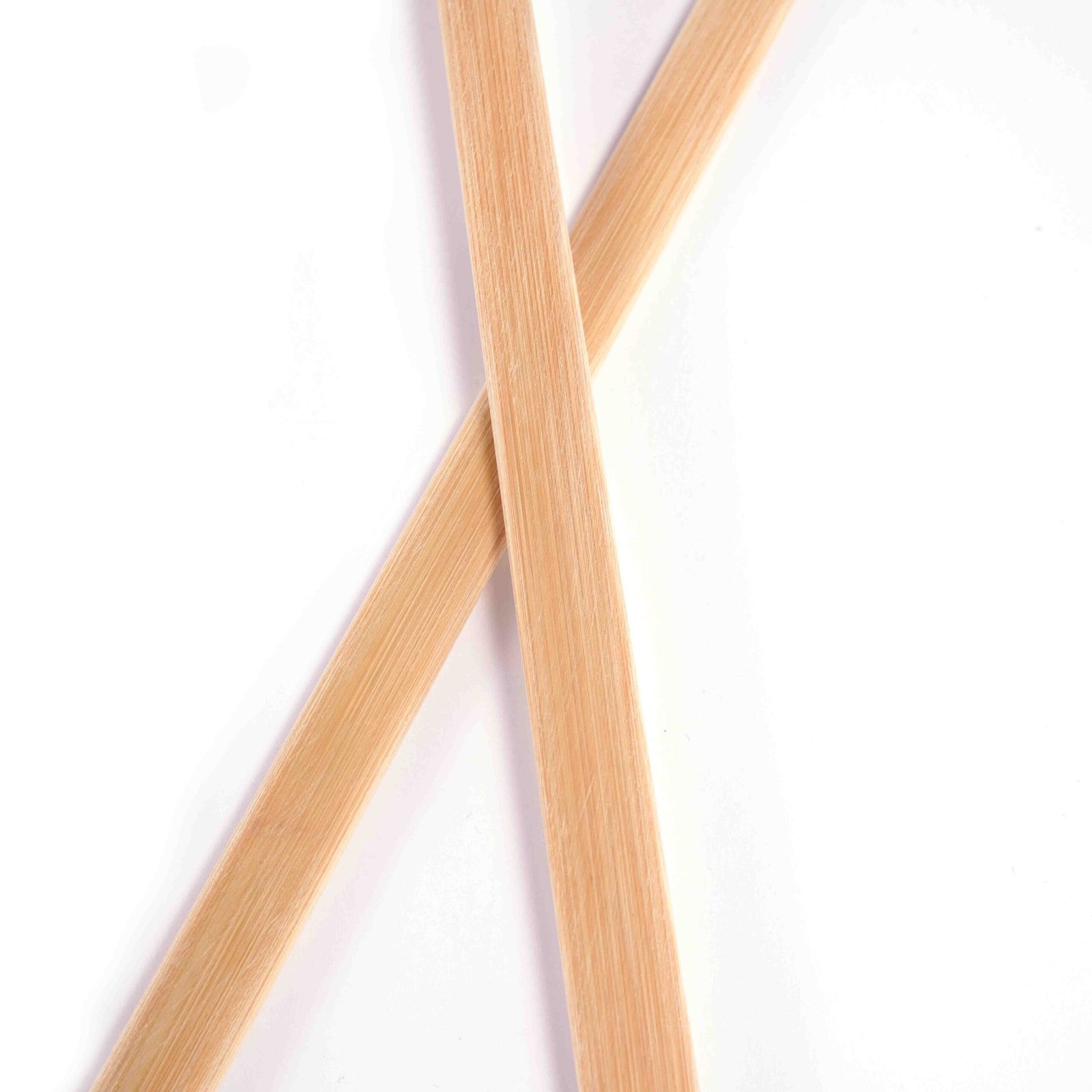 JINLEI bamboo bachi, close-up of crossed pair showing natural bamboo fiber texture and flat surface detail