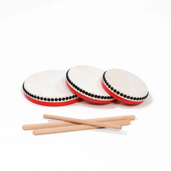 JINLEI eisa paranku, three red handheld drums with cowhide heads, black tack trim and wooden bachi sticks