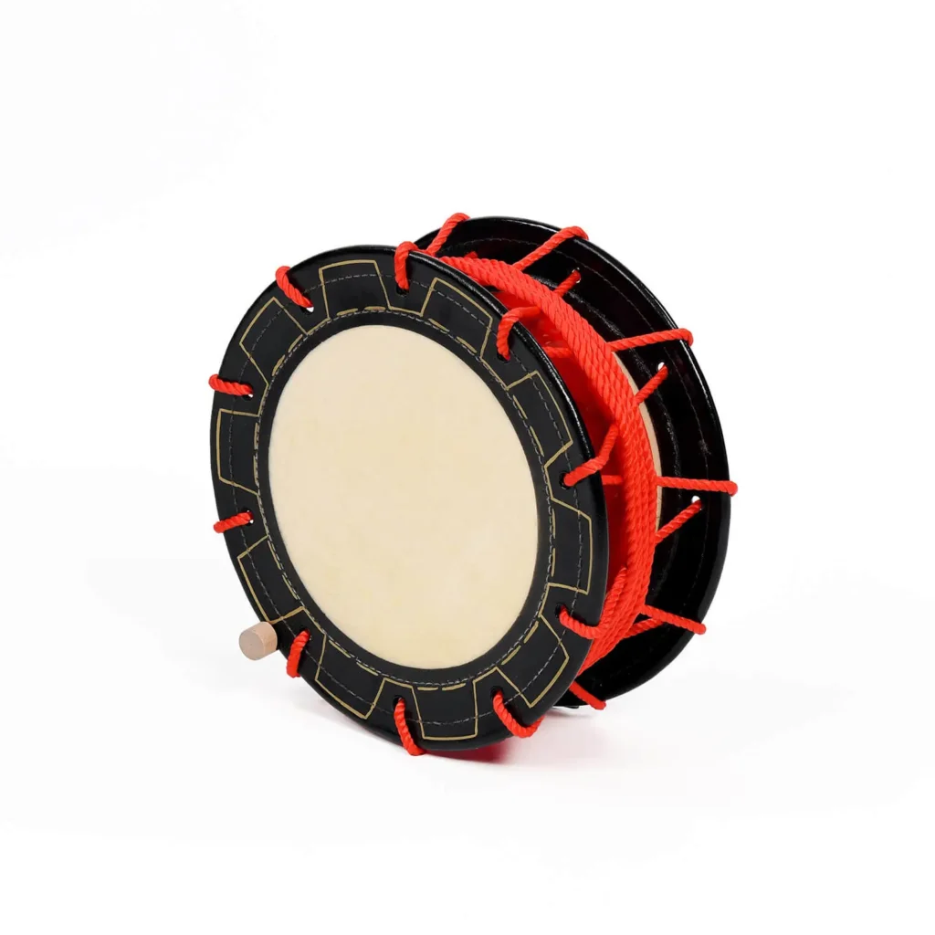 JINLEI eisa shime daiko, front angle view showing black decorated rim, cowhide drumhead, red rope tuning and wooden bachi handle