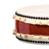 Close-up of JINLEI Hira Daiko African Padauk Kurinuki drum showing cowhide drumhead edge with black bead tacking, natural rawhide lacing and rich deep red African padauk wood grain shell