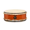 JINLEI Hira Daiko Ash Wood Kurinuki drum front view showing flat wide-body design with cowhide drumhead, black bead tacking, rawhide lacing and glossy orange-red ash wood shell with ornate gold hardware