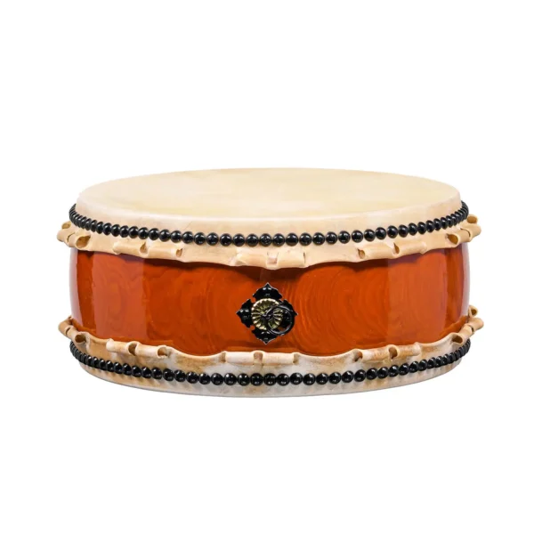 JINLEI Hira Daiko Ash Wood Kurinuki drum front view showing flat wide-body design with cowhide drumhead, black bead tacking, rawhide lacing and glossy orange-red ash wood shell with ornate gold hardware