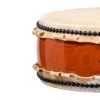 Close-up of JINLEI Hira Daiko Ash Wood Kurinuki drum showing cowhide drumhead edge with black bead tacking, natural rawhide lacing and vibrant glossy orange-red ash wood grain shell