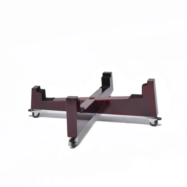 JINLEI Nagado Daiko X Stand angled view showing deep burgundy lacquered cross-shaped wood base with four notched drum cradle ends and rubber caster wheels