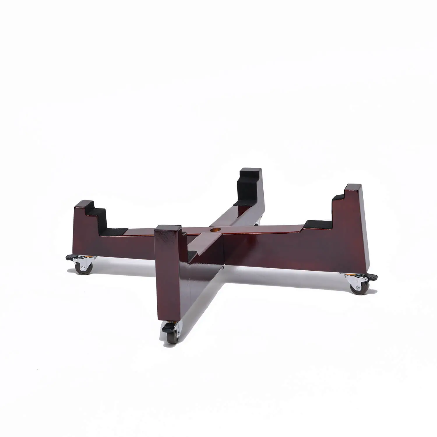 JINLEI Nagado Daiko X Stand angled view showing deep burgundy lacquered cross-shaped wood base with four notched drum cradle ends and rubber caster wheels