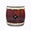 JINLEI Nagadou Daiko Kapiac drum front view showing deep burgundy barrel-shaped body with glossy lacquer finish, black bead tacking and black iron diamond-shaped ring hardware