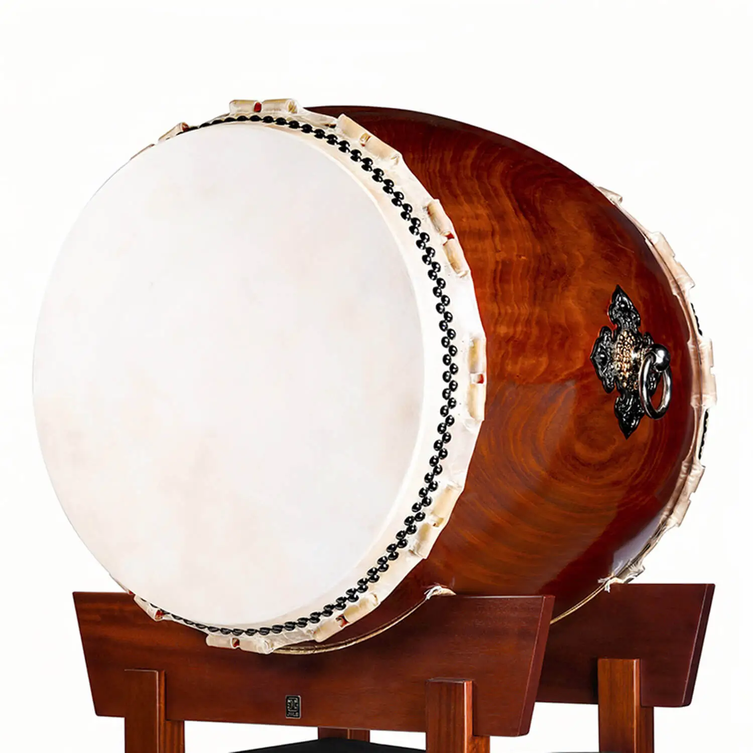 JINLEI O-Daiko Akatsuki Series side angle view showing large cowhide drumhead with black bead tacking, rawhide lacing and rich swirling wood grain shell on mahogany stand