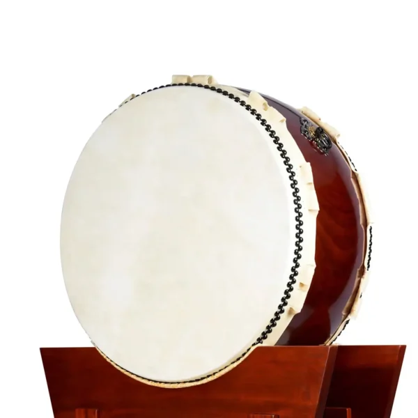 JINLEI O Hira Daiko Kurinuki large flat drum front view showing wide cowhide drumhead with black bead tacking, rawhide lacing and deep reddish-brown wood shell mounted on mahogany yagura stand