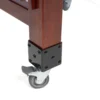 Close-up of JINLEI O-Hira Daiko Tower Stand leg base showing black studded metal corner bracket on mahogany pillar with heavy-duty lockable swivel rubber caster wheel