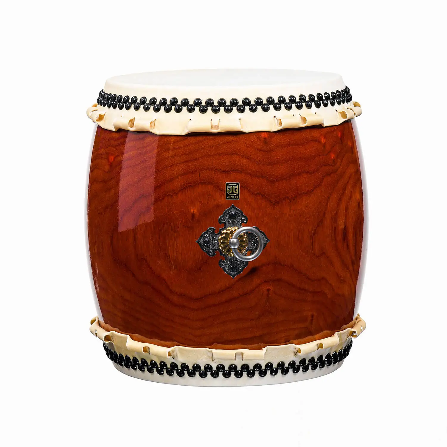 Nagado Daiko African Padauk hollowed-out solid wood drum front view showing deep red-brown barrel-shaped body with bold swirling grain pattern, black bead tacking and ornate iron ring hardware