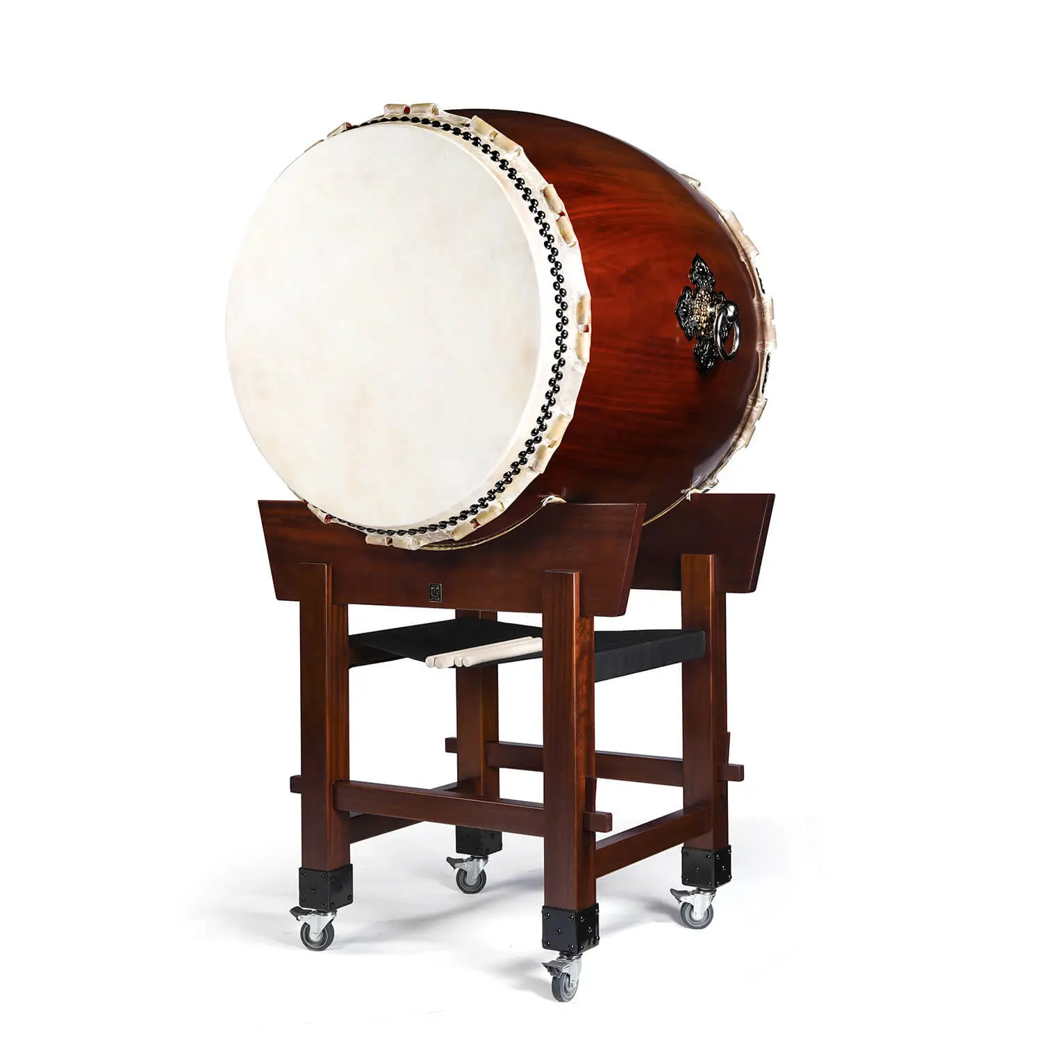 O-Daiko Kapiac Do Series full view showing large taiko drum with cowhide drumhead and black bead tacking mounted on mahogany yagura tower stand with caster wheels and drumsticks