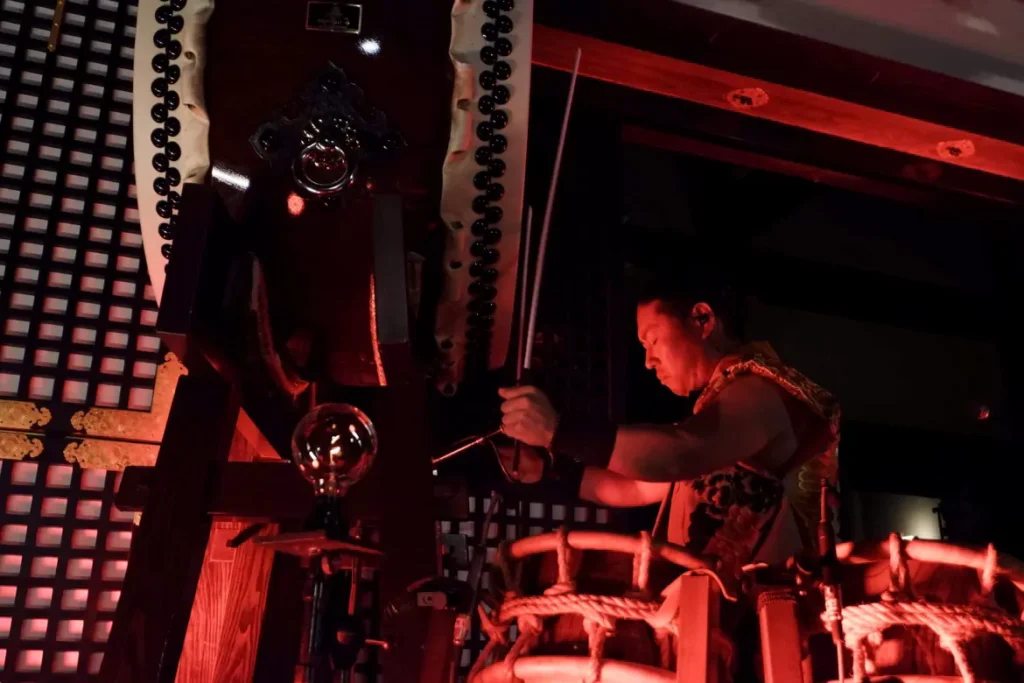 A drummer performing with intense focus on a large Odaiko, illustrating that buying a Taiko drum is not just a simple transaction, but the start of a long journey of dedication and artistic expression.
